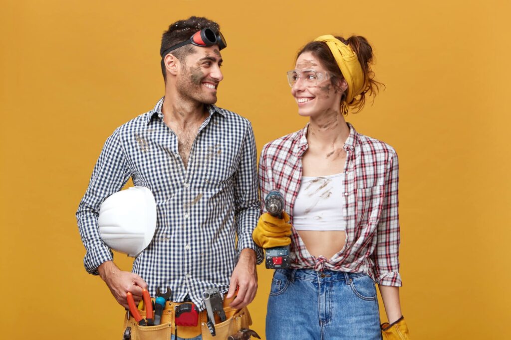 people-job-occupation-profession-two-talented-cheerful-young-craftsmen-enjoying-working-together-pretty-girl-protective-goggles-with-drill-looking-her-handsome-colleague-smiling (1)